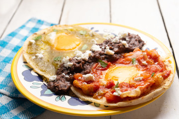 Mexican fried eggs with green and red sauce also called 