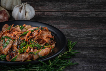  Spicy Thai food ingredients include bacon, red prick, garlic, lemongrass, basil, wood cutting and herbs on the old wood floor