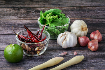  Spicy Thai food ingredients include bacon, red prick, garlic, lemongrass, basil, wood cutting and herbs on the old wood floor