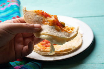 Mexican quesadilla with corn tortilla and piquant sauce also called 