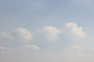 Three cute pastel fluffy cloud in the sky