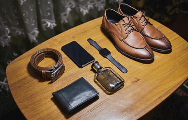 different accessories of a businessman for creating a style of a people lie on a wooden background