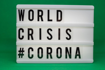 a light box with the inscription: WORLD CRISIS #CORONA