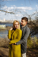 guy hugs a beautiful girl in the park