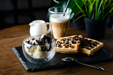 chocolate ice cream with nuts in a glass bowl