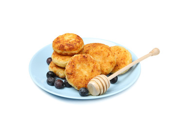 Plate with cheese pancakes and blueberry isolated on white background