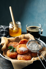Breakfast of cheese pancakes on wooden background, close up