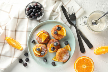 Breakfast of cheese pancakes on white background, top view