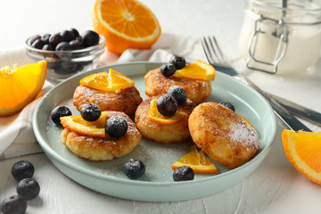 Breakfast of cheese pancakes on white background, close up