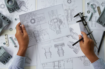 Engineer technician designing drawings mechanical parts engineering Engine.manufacturing factory...