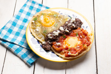 Mexican fried eggs with green and red sauce also called 