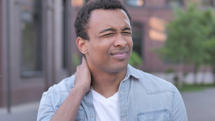 Fototapeta premium Tired African Man with Neck Pain