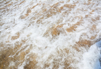 Fototapeta na wymiar White light seafoam waves on the golden sand beach.