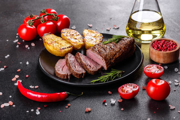 Ribeye steak with potatoes, onions and cherry tomatoes
