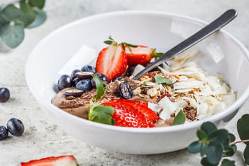 Healthy breakfast bowl with granola, berries and coconut.