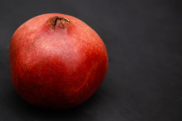 Closeup red pomegranate Isolated on a black background.
