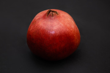 Closeup red pomegranate Isolated on a black background.