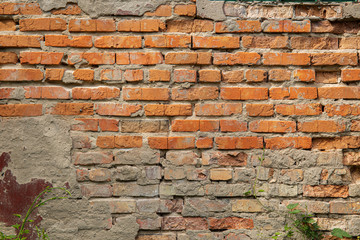 Weathered stained old brick wall for background