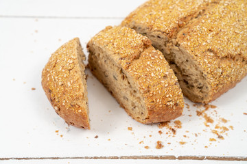 Sliced Bread With Sesame Seeds On The White Wooden Boards