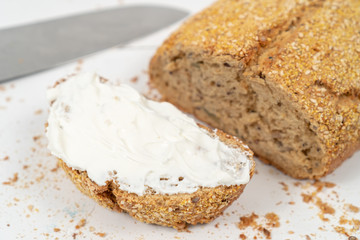 Sliced Bread With Sesame Seeds And Sour Cream On The White Wooden Boards