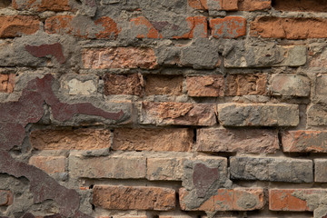 Weathered stained old brick wall for background