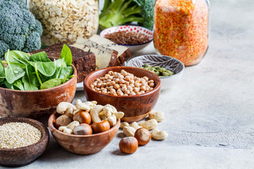 Vegan sources of protein, background. Tofu, chickpeas, lentils, nuts, spinach and broccoli - vegetable proteins.