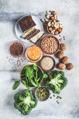 Vegan sources of protein, background. Tofu, chickpeas, lentils, nuts, spinach and broccoli - vegetable proteins.