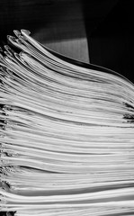 Paper documents stacked in archive. Documents on the shelves of archive room. Office shelves in the closet full of files. black and white photo