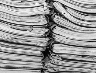 Paper documents stacked in archive. Documents on the shelves of archive room. Office shelves in the closet full of files. black and white photo