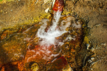 mineral water flowing through rusted pipe