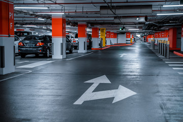 Parking garage - interior shot of multi-story car park, underground parking with cars