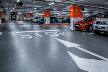 Fototapeta premium Parking garage - interior shot of multi-story car park, underground parking with cars