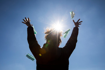 Girl freeing herself from the protective mask after overcoming illness, virus, covid-19. coronavirus