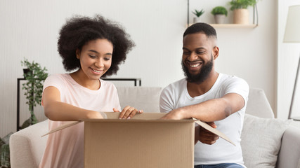 African american couple opens box from online store