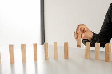 Hand holding blocks wood game, Concept Risk of management and strategy plan, growth business success process and team work