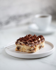 Tiramisu with coffee on white marble background