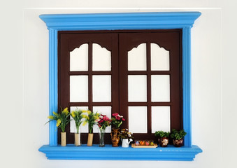 Fototapeta na wymiar Brown window, white background and blue window frame 