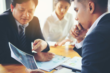 Group businessman meetings to brainstorm, analyze and plan for marketing.