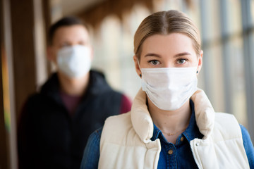 Man and woman wearing protective mask against transmissible infectious diseases and as protection...