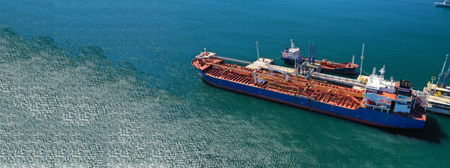 Aerial drone ultra wide top down photo of industrial LPG gas tanker ship cruising in low speed near...