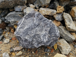 Limestone rock on nature background. Limestone is a sedimentary rock composed mostly of the mineral calcite, It is a basic building block of the construction industry.