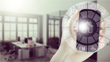 Hand of human holding smartphone with double exposure of smart home interface. Concept of automation.