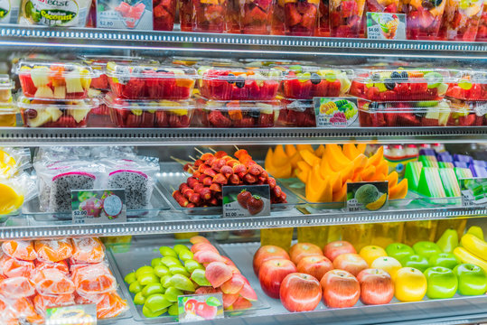 Packages with fruits displayed in a commercial refrigerator