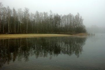 Foggy, wintery images of a lake: the Plas in Rotselaar in Flanders, Belgium. De Plas is an artificial lake created by sand extraction.  Swimming and windsurfing in the summer.