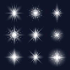 Fototapeta premium Set of realistic glare lightning white stars vector illustration. Light effects and cold colour. Lens flares or rays flat style. Isolated on dark background