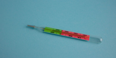 mercury thermometer, isolated on blue background temperature meter,
