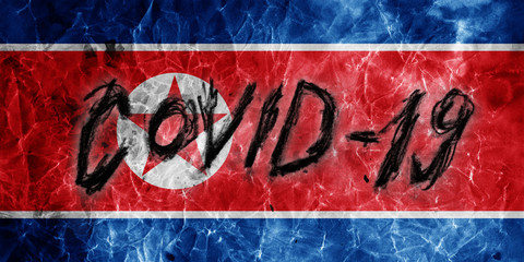 Grunge flag of North Korea with hand drawn Coronavirus name on it. 2019 - 2020 Novel Coronavirus (2019-nCoV) concept, for an outbreak occurs in North Korea.