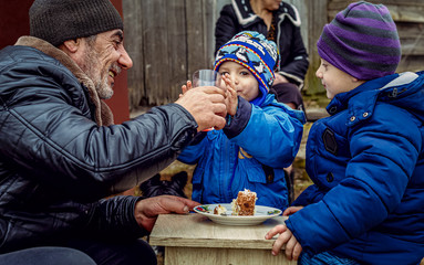 bearded grandfather with two little grandchildren brothers