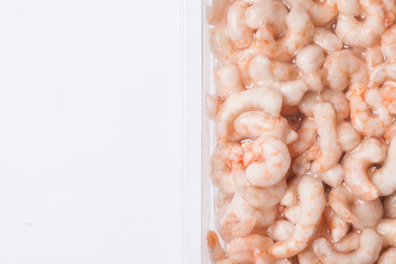 Frozen shrimp isolated. Plastic vacuum packaging. Empty copy space seafood background. 