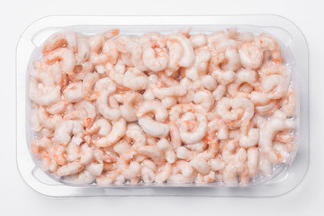 Frozen shrimp isolated. Plastic vacuum packaging. Seafood background.